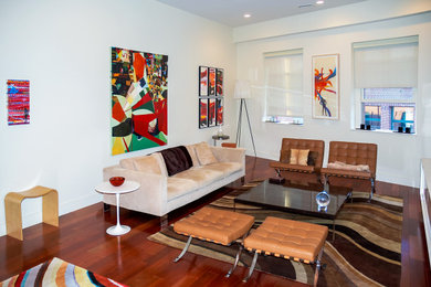 Example of a mid-sized trendy dark wood floor and brown floor living room design in Boston with white walls, no fireplace and no tv