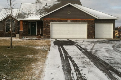 Inspiration for a large timeless gray two-story metal gable roof remodel in Minneapolis
