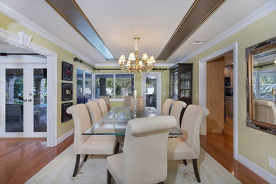Kitchen/dining room combo - mid-sized coastal medium tone wood floor and beige floor kitchen/dining room combo idea in Other with green walls and no fireplace