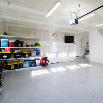 Interior of garage with drywall, lighting and TV hook up.