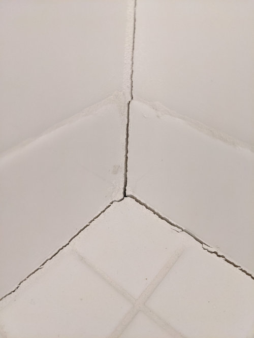 Large settlement(?) cracks in shower floor, new house.
