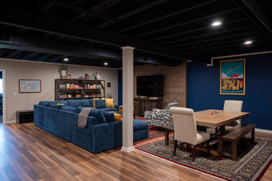 Example of a large classic formal and open concept vinyl floor, brown floor and exposed beam living room design in Detroit with a wall-mounted tv