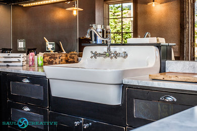 Example of a mid-sized cottage eat-in kitchen design in Other with a farmhouse sink, shaker cabinets, black cabinets, granite countertops and stone slab backsplash