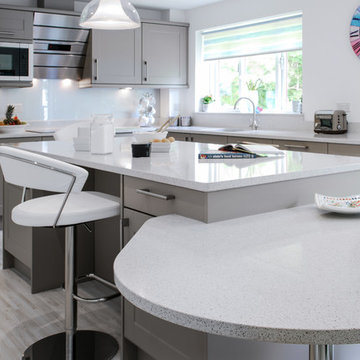 Curved shaker style kitchen with Island and seating area