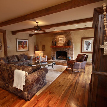 A casual Den with reclaimed wood flooring, heavily textured and glazed walls.