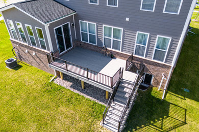 Deck - mid-sized contemporary backyard ground level metal railing deck idea in Other with no cover