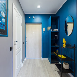 Photo of a small eclectic front door in Saint Petersburg with blue walls, light hardwood floors, a single front door, a light wood front door and beige floor.