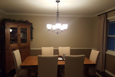 Mid-sized transitional dark wood floor enclosed dining room photo in Milwaukee with beige walls and no fireplace