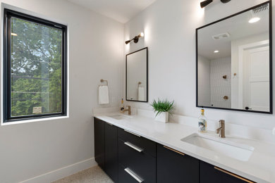 Mid-sized minimalist kids' white tile and ceramic tile porcelain tile, beige floor and double-sink bathroom photo in Austin with flat-panel cabinets, black cabinets, white walls, an undermount sink, quartz countertops, white countertops and a built-in vanity