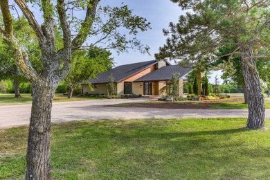 Example of a mid-sized cottage beige one-story mixed siding exterior home design in Oklahoma City with a tile roof