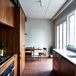 This is an example of a midcentury kitchen in Melbourne with marble benchtops, brick floors, red floor and yellow benchtop.
