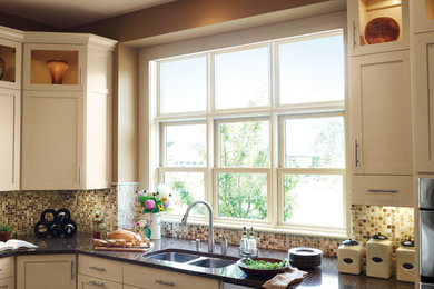 Large elegant kitchen photo in Vancouver with shaker cabinets, white cabinets, a double-bowl sink, granite countertops, multicolored backsplash and mosaic tile backsplash