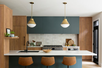 Mid-century modern l-shaped light wood floor and beige floor eat-in kitchen photo in Toronto with an undermount sink, flat-panel cabinets, medium tone wood cabinets, quartz countertops, beige backsplash, ceramic backsplash, paneled appliances, an island and beige countertops