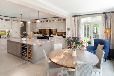 Inspiration for a large traditional kitchen in Surrey with shaker cabinets, white cabinets, granite benchtops, mirror splashback, with island and white benchtop.