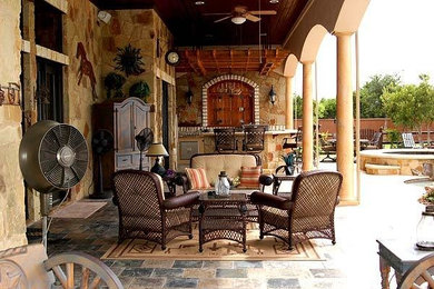 Inspiration for a mid-sized rustic backyard tile patio kitchen remodel in Orange County with a roof extension