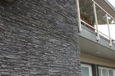 Inspiration for a huge modern beige two-story stone exterior home remodel in Vancouver