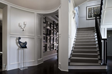 Inspiration for an expansive traditional foyer in Orlando with white walls and dark hardwood floors.