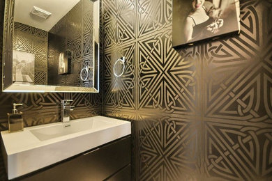 Powder room - small contemporary black tile porcelain tile and gray floor powder room idea in Toronto with flat-panel cabinets, black cabinets, a two-piece toilet, black walls, a wall-mount sink and quartz countertops