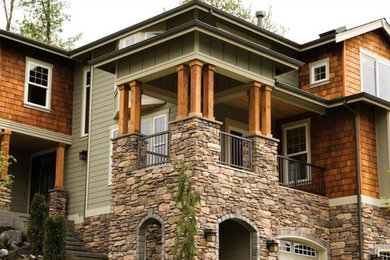 Large traditional multicolored three-story mixed siding house exterior idea in Other with a hip roof