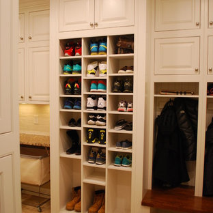 Photo of a large traditional utility room in Cleveland with a submerged sink, raised-panel cabinets, white cabinets, engineered stone countertops, yellow walls, porcelain flooring and a side by side washer and dryer.