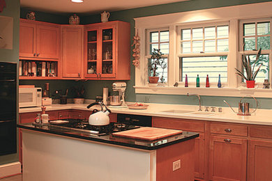 Mid-sized traditional l-shaped eat-in kitchen in DC Metro with a double-bowl sink, with island, recessed-panel cabinets, brown cabinets, quartzite benchtops, linoleum floors, beige floor and stainless steel appliances.