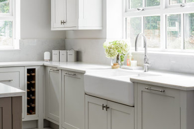 Inspiration for a traditional eat-in kitchen in Other with a farmhouse sink, shaker cabinets, grey cabinets, quartzite benchtops, white splashback, engineered quartz splashback, panelled appliances, with island and white benchtop.