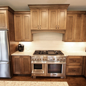 Two Toned Kitchen with White Island and Great Room Stacked Stone Fireplace