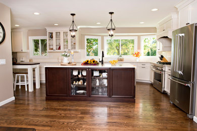 Inspiration for a large timeless l-shaped medium tone wood floor and brown floor eat-in kitchen remodel in Detroit with an undermount sink, flat-panel cabinets, white cabinets, quartz countertops, white backsplash, subway tile backsplash, stainless steel appliances, two islands and white countertops