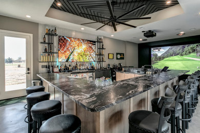 Large minimalist u-shaped gray floor seated home bar photo in Kansas City with an undermount sink, light wood cabinets, concrete countertops, beige backsplash and black countertops
