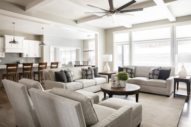 Mid-sized transitional open concept dark wood floor and brown floor living room photo in Milwaukee with gray walls, a standard fireplace, a stone fireplace and a wall-mounted tv