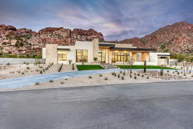 Example of a large southwest beige one-story mixed siding exterior home design