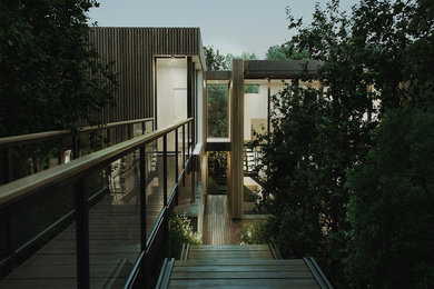 Large contemporary two-storey house exterior in Montreal with wood siding and a flat roof.
