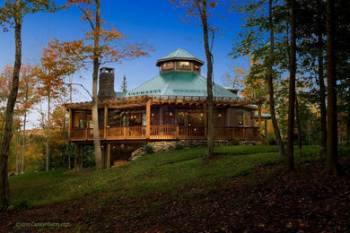 Example of a large transitional brown two-story wood exterior home design in Burlington with a shed roof