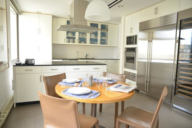 Inspiration for a large contemporary l-shaped ceramic tile and gray floor eat-in kitchen remodel in Orange County with white cabinets, stainless steel appliances, an island, a drop-in sink, flat-panel cabinets, granite countertops and beige backsplash