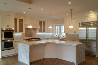 Elegant kitchen photo in Boston with gray backsplash and stainless steel appliances