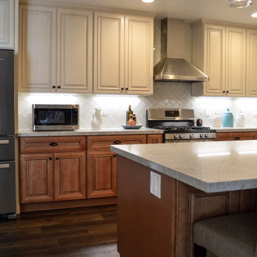 Antique white kitchen upper cabinet with cinnamon cabinets and Quartz countertop