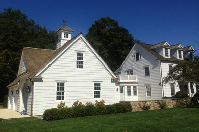 Inspiration for a timeless white three-story wood exterior home remodel in New York