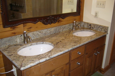 Bathroom - mid-sized ceramic tile bathroom idea in Baltimore with an undermount sink, raised-panel cabinets, medium tone wood cabinets, granite countertops and beige walls
