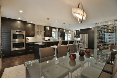 Inspiration for a large contemporary dark wood floor eat-in kitchen remodel in Toronto with shaker cabinets, quartzite countertops, stainless steel appliances and an island