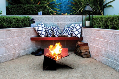 Design ideas for a mid-sized modern courtyard patio in Sydney with a fire feature.