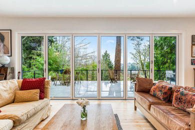 Huge elegant light wood floor living room photo in Seattle