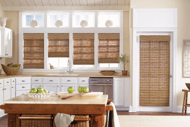 Inspiration for a mid-sized timeless l-shaped light wood floor and beige floor enclosed kitchen remodel in San Diego with recessed-panel cabinets, an island, a drop-in sink, white cabinets, wood countertops and stainless steel appliances