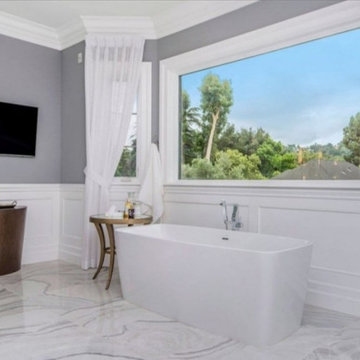 Six foot soaker tub and marble flooring in bathroom remodel