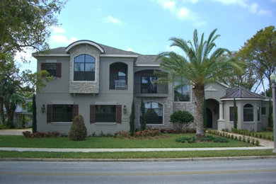 Example of a huge beige three-story mixed siding exterior home design in Tampa with a hip roof