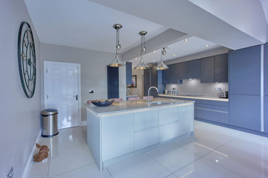 Photo of a large modern kitchen/diner in Other with flat-panel cabinets, grey cabinets, quartz worktops, beige splashback, an island and beige worktops.