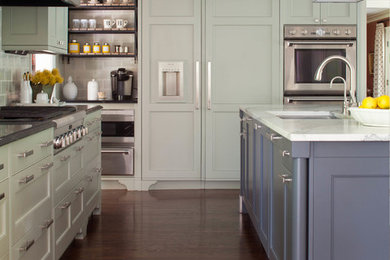 Inspiration for a large transitional l-shaped medium tone wood floor eat-in kitchen remodel in Denver with a drop-in sink, beaded inset cabinets, green cabinets, marble countertops, white backsplash, glass tile backsplash, stainless steel appliances and an island