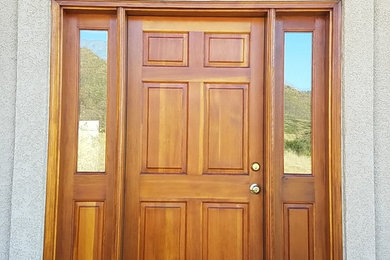 Example of a single front door design in Other with a brown front door