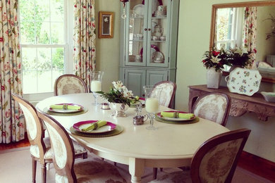 This is an example of a mid-sized scandinavian separate dining room with yellow walls and medium hardwood floors.