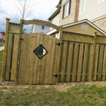 Your typical semi-privacy fence with lattice; custom gate