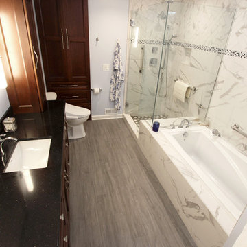 White and Gray MasterBath with Marble Look and Herringbone Tiled Shower